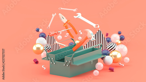 Toolbox amidst colorful balls on a pink background.-3d rendering. photo