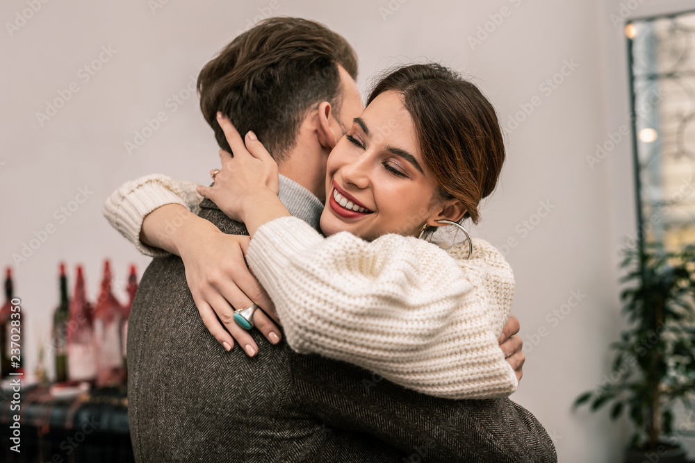 Impressed and happy woman hugging her husband Impressed and happy woman hugging her husband