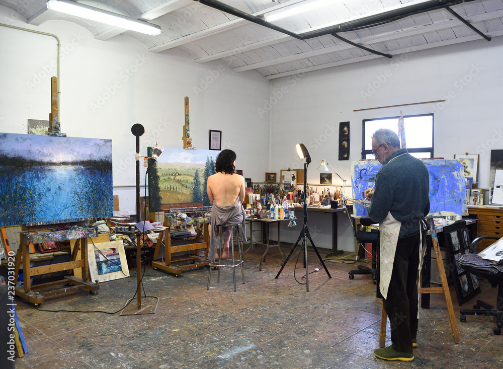 painter painting a model in the studio painter painting a model in the studio
