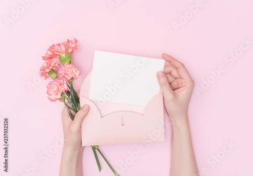 female hand hold flower with letter