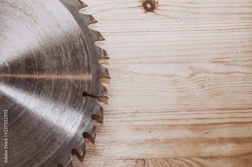 Bild auf Leinwand Circular saw on a wood background