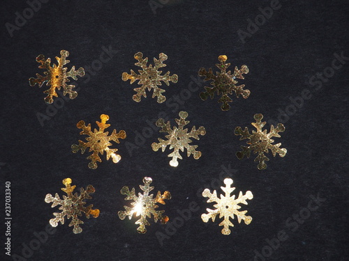 Colorful shiny stars on a black background. Winter background.