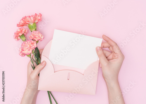 female hand hold flower with letter