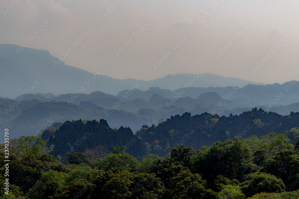 Thakhek, Laos - April 21 2018: Stunning limestone hills surrounded by green in the Khammouane province in Laos