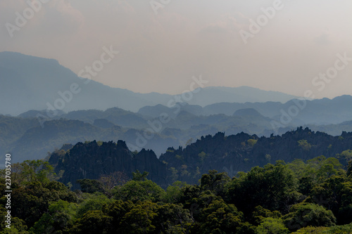 Thakhek, Laos - April 21 2018: Stunning limestone hills surrounded by green in the Khammouane province in Laos © Dino