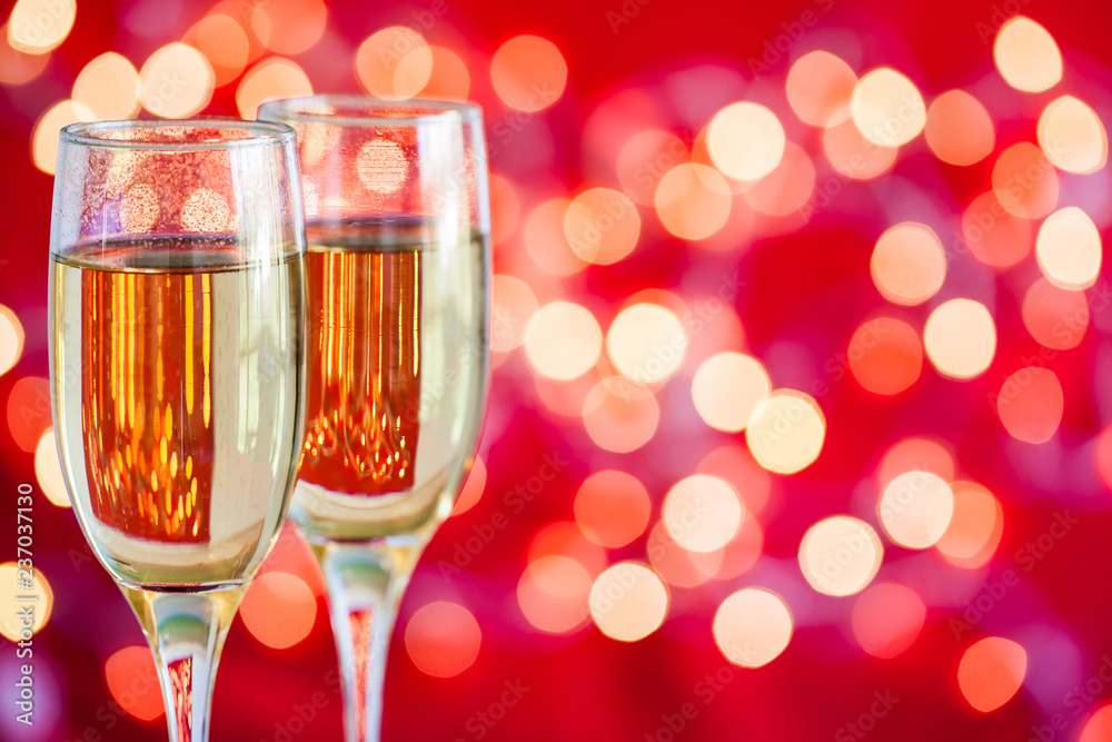 Champagne glasses on light bokeh red background Champagne glasses on light bokeh red background