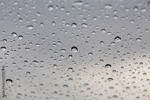 Close-up water drop. Water drops on glass surface as background. Drops of rain on glass. Sky background. Thailand.