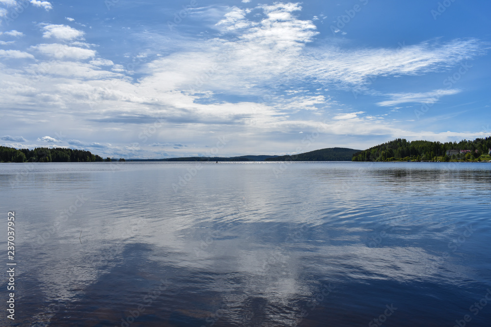 Sky reflects into the lake's surface