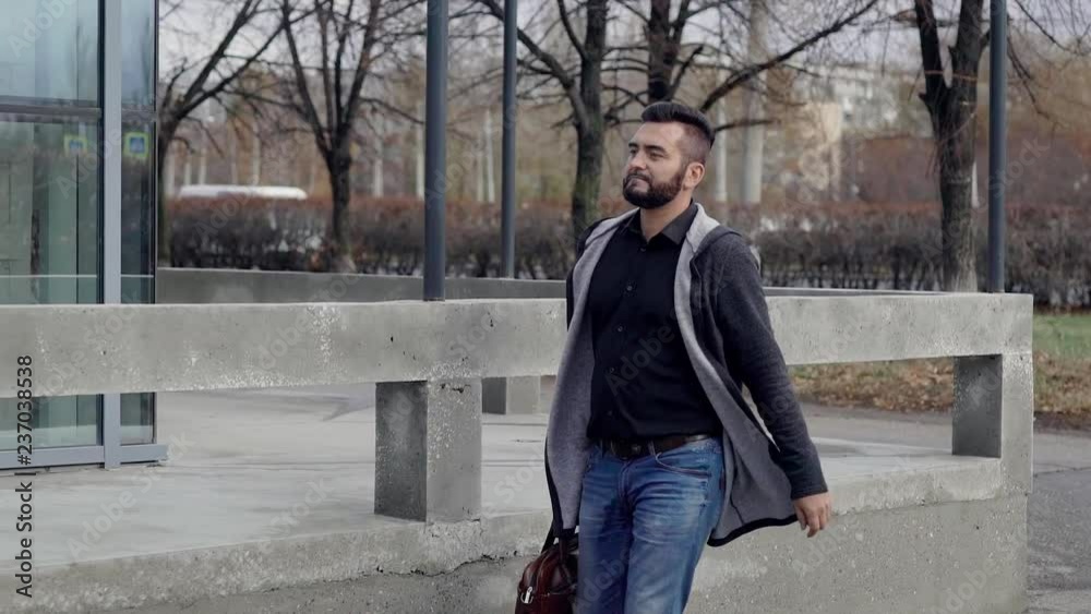 A business man with a briefcase, walking through the city. A man walks down the street on business. A business man with a briefcase, walking through the city. A man walks down the street on business.
