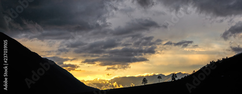 Arkhyz. The setting sun causes low clouds in the Sofia Valley photo