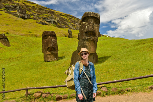 Bilde på lerret Tourist young  woman near Moai statues in the Rano Raraku Volcano in Easter Isla