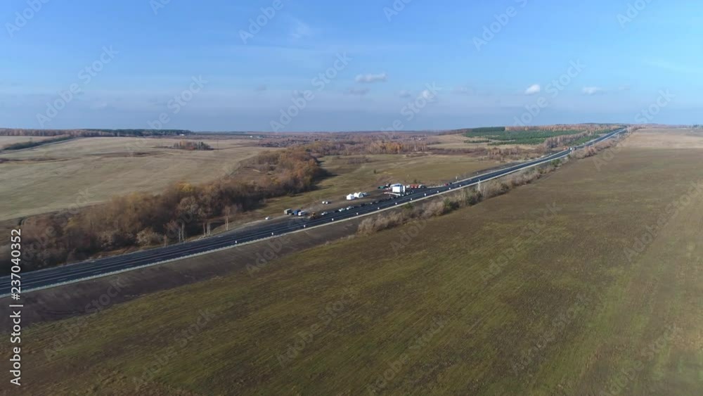 Aerial view of traffic on two lane road through countryside and cultivated fields Aerial view of traffic on two lane road through countryside and cultivated fields