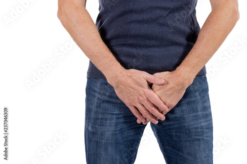 Man holding his urethra in pain. Men problems on white background. Medical concept