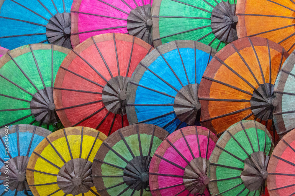 Fototapeta premium Colorful parasols texture at night souvenir market, Luang Prabang city, Laos.