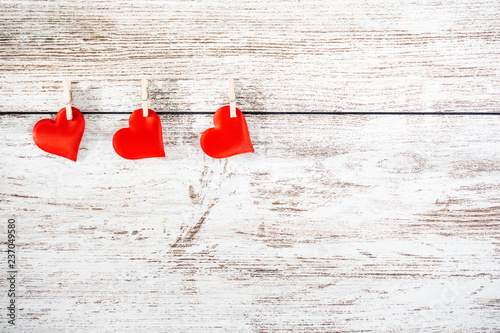 Hearts hanged on a wooden background. Valentines Day concept.