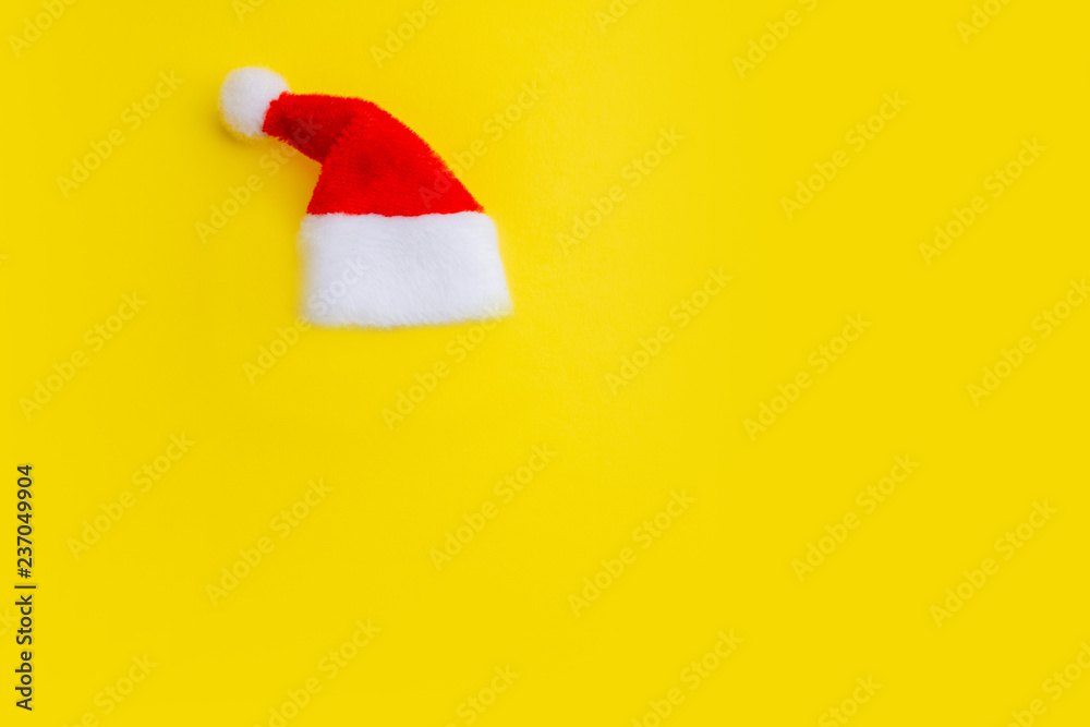 Red Santa Claus hat on a yellow background. Isolate The concept of the New Year and Christmas. Copy space. Red Santa Claus hat on a yellow background. Isolate The concept of the New Year and Christmas. Copy space.