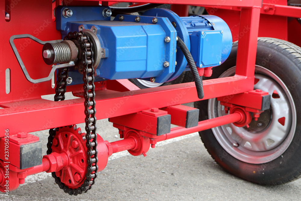 Image of electric motor and chain drive of an agricultural machine.