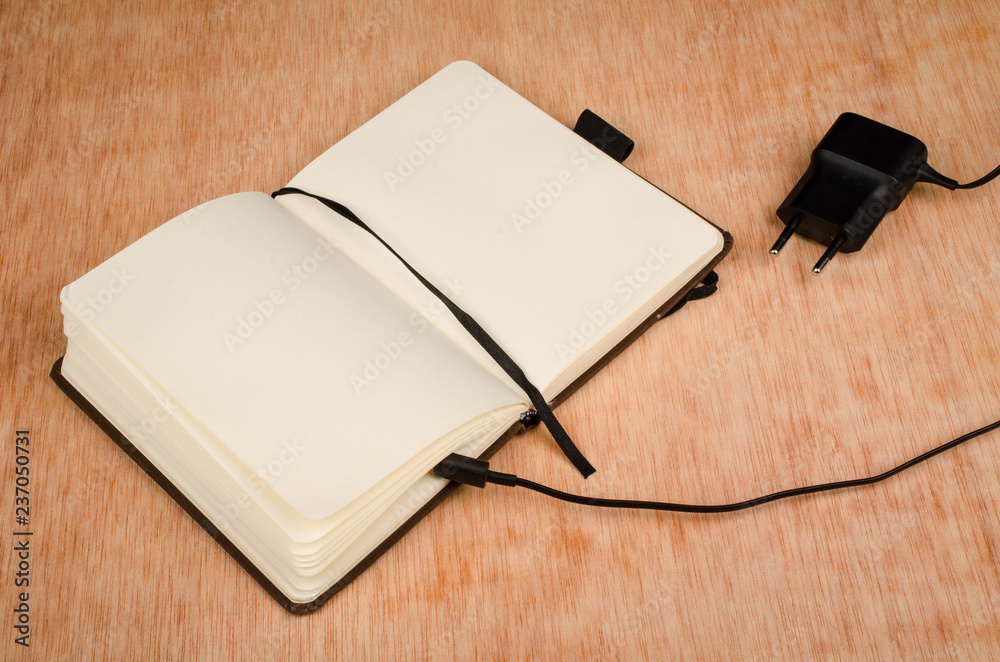 Small paper notebook and battery charger Small paper notebook and battery charger