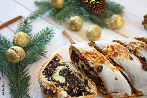 Poppy seed cake surrounded by spruce branches and gilded nuts