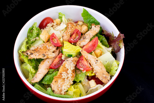 Chicken Quinoa salad with fresh vegetables with isolated black background