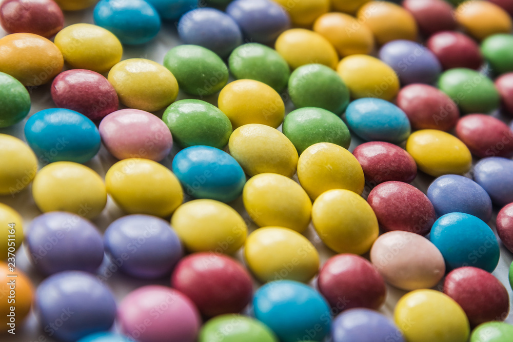 Background of colored sweet dragees. Shallow DOF. Selective focus Background of colored sweet dragees. Shallow DOF. Selective focus