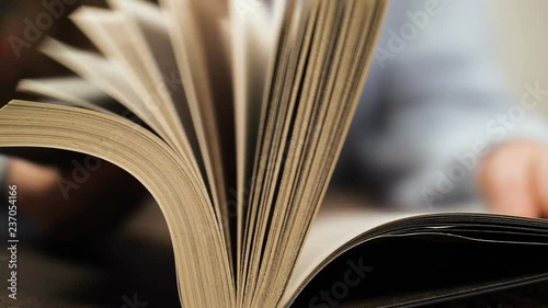 Book pages turning in slow motion. Close up.