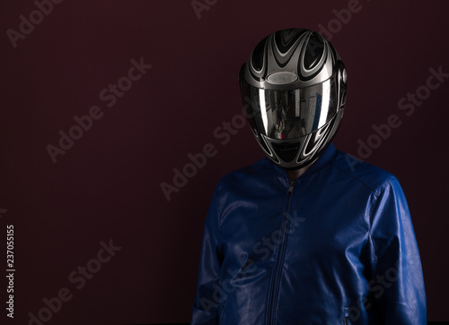 studio portrait of a biker on a black background © serikbaib