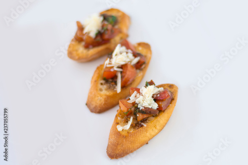 Delicious bruschetta with tomato and cheese with isolated white background