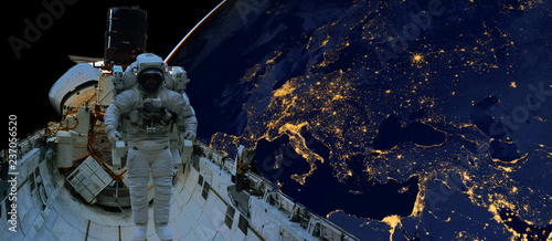 astronaut spacewalk at night from the dark side of the earth planet. Elements of this image furnished by NASA d photo