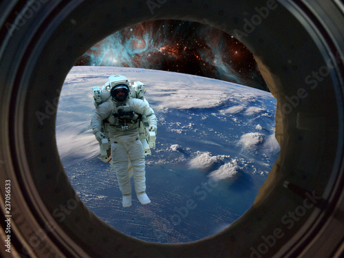 astronaut spacewalk near the earth. view from the space ship illuminator. Elements of this image furnished by NASA f