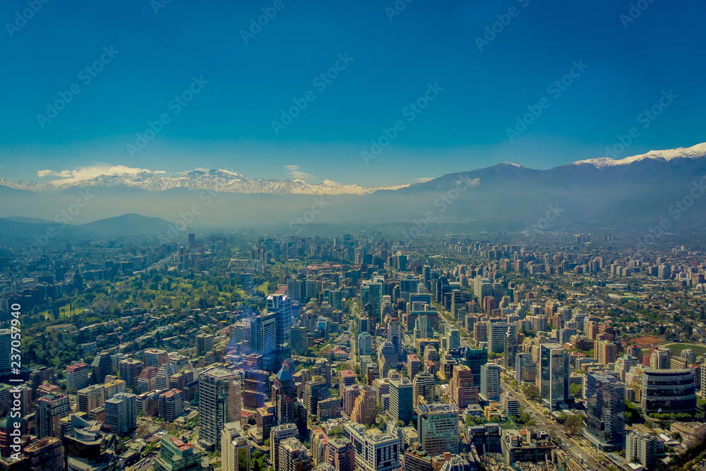 Fototapeta premium Gorgeous view of Santiago with a snowy mountain in the horizont viewed from Cerro San Cristobal, Chile
