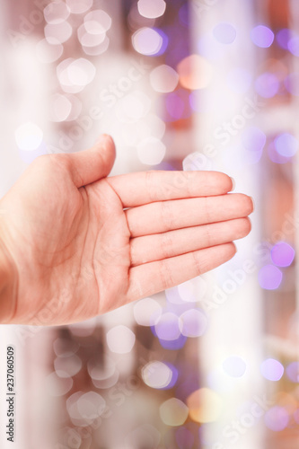 Open hand on the background of blurred bokeh.