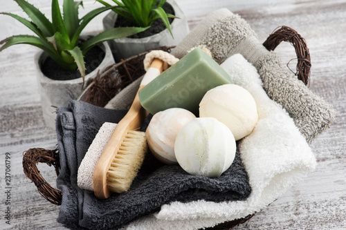 Folded towels in bascket with bath bombs