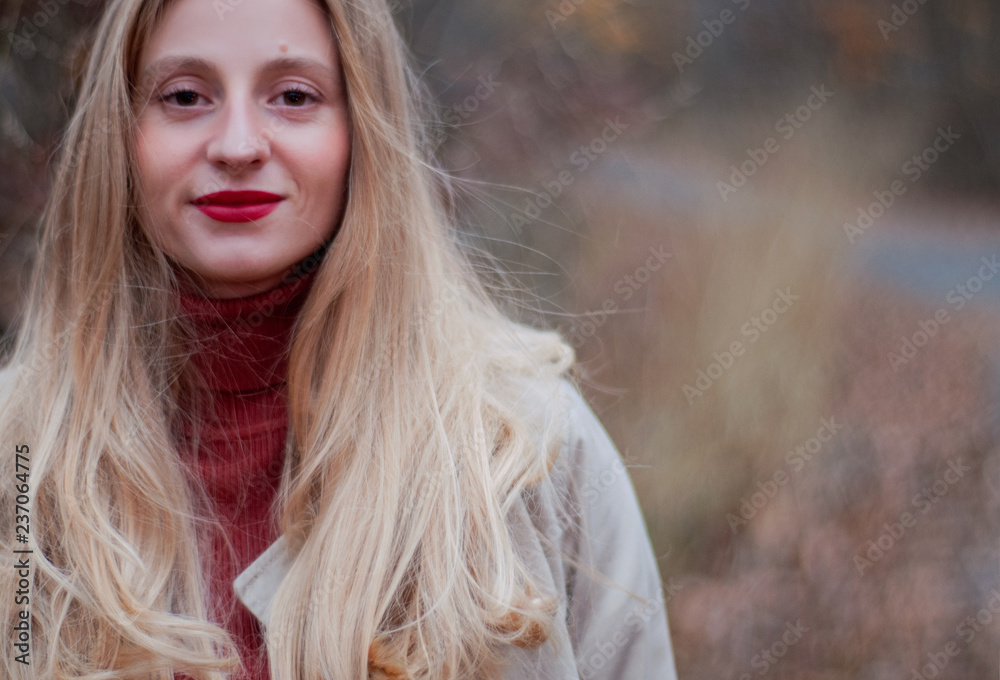 Beautiful blonde woman with long hair in autumn forest Beautiful blonde woman with long hair in autumn forest