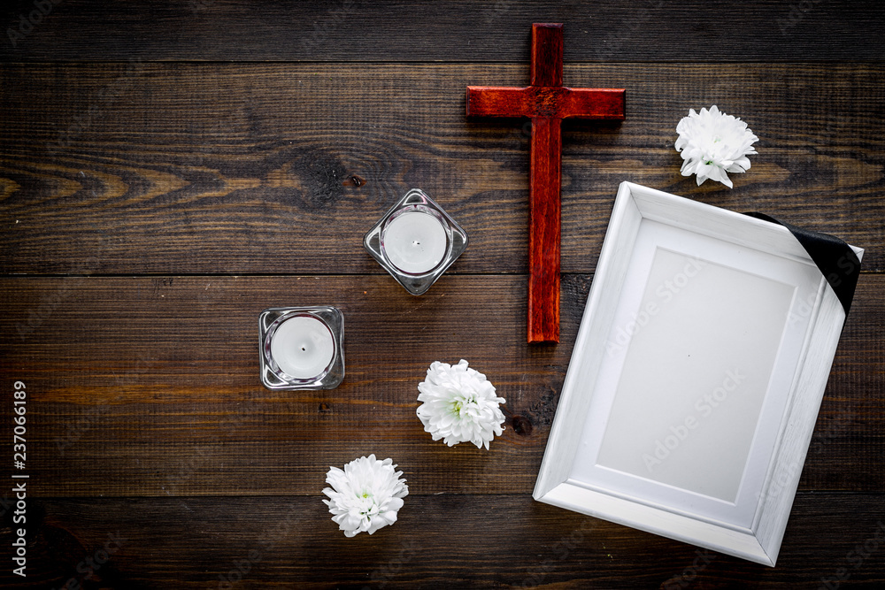 Funeral. Mockup of portrait of the deceased, of dead person. Frame with  black ribbon near flowers, candles and cross on dark wooden background top  view copy space Stock Photo | Adobe Stock