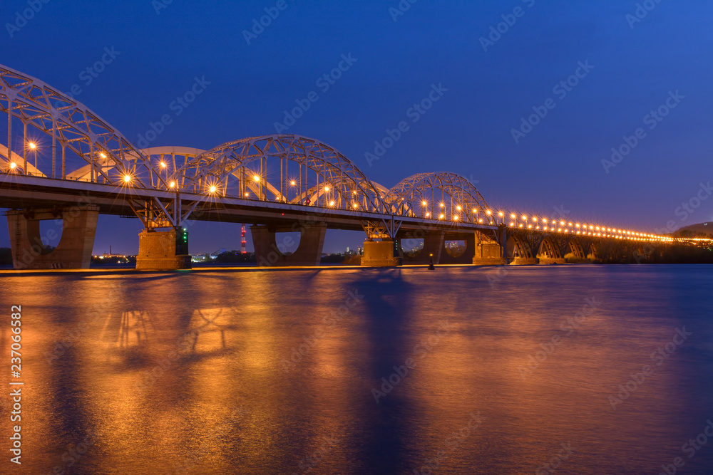 The bridge across the Dnipro river in Kiev, Ukraine in the spring The bridge across the Dnipro river in Kiev, Ukraine in the spring