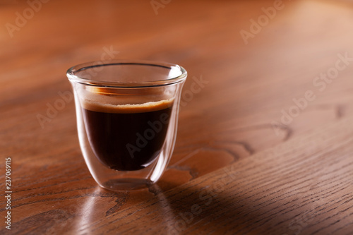 Cup of espresso coffee on wodden background.