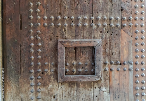 Part of the Valencia city ancient gates. Watch towers of Quart. Old wooden gate texture. Strong fortress, Spain.