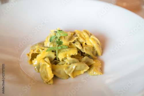 traditional italian agnolotti pasta in a plate in a restaurant photo