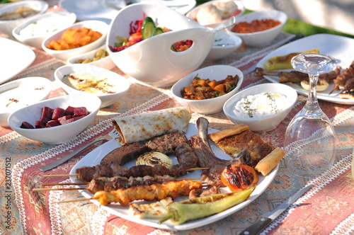Traditional Cypriot meze and kebap barbecue party in the garden with delicious mix meat and chicken kebaps