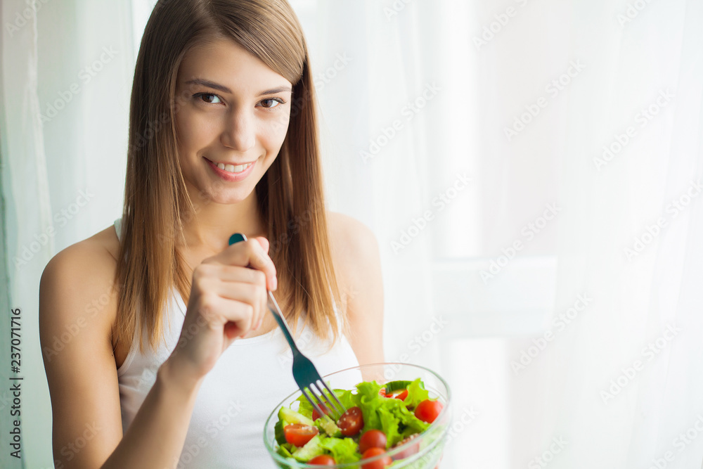 Diet and health. Young woman eating healthy salad after workout Diet and health. Young woman eating healthy salad after workout