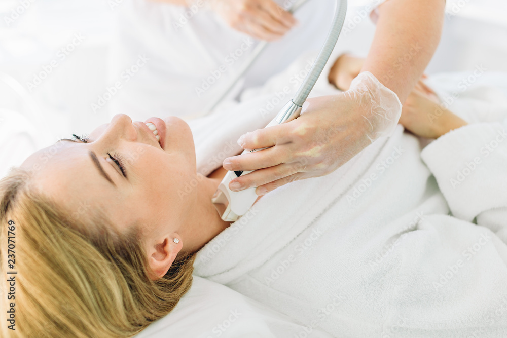 Attractive young groomed woman pampers herrself with a facial or a body treatment in a luxury spa and beauty salon. Fractional laser dermal resurfacing have proven to be effective at clinic Attractive young groomed woman pampers herrself with a facial or a body treatment in a luxury spa and beauty salon. Fractional laser dermal resurfacing have proven to be effective at clinic