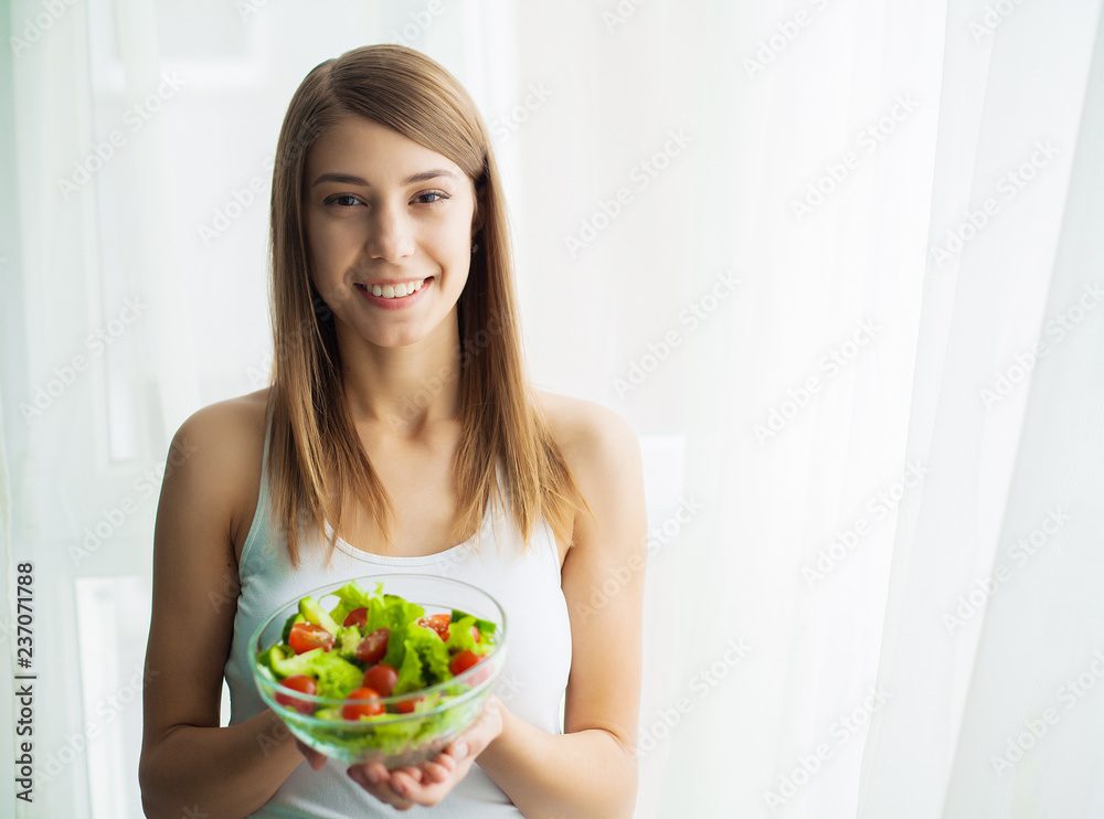 Diet and health. Young woman eating healthy salad after workout Diet and health. Young woman eating healthy salad after workout