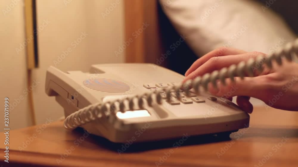Using hotel room phone to dial number.
Using hotel room phone to dial number.