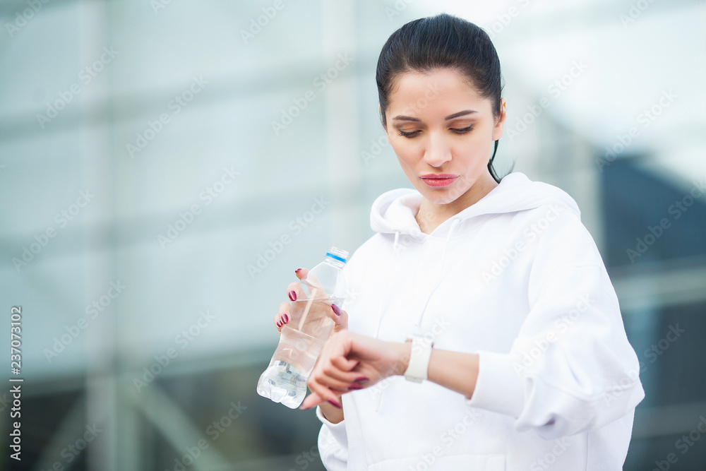 Fitness outdoor. Woman drinking bottle of water Fitness outdoor. Woman drinking bottle of water