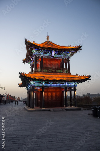 Beautiful illuminated traditional chinese temple on the Xi'An City Walls at evening, China