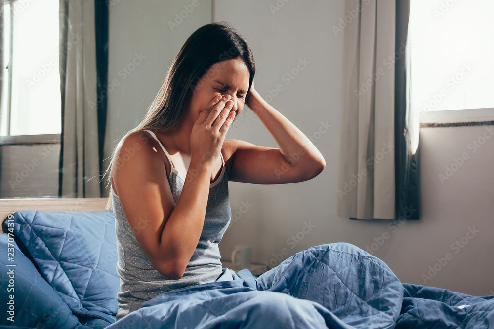 Sinus pain, sinus pressure, sinusitis. Sad woman holding her nose and head because sinus pain. Sinus ache causing very paintful headache. Sinus pain, sinus pressure, sinusitis. Sad woman holding her nose and head because sinus pain. Sinus ache causing very paintful headache.