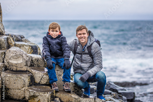 Father and son at Giants causeway in autumn, Northern Ireland photo