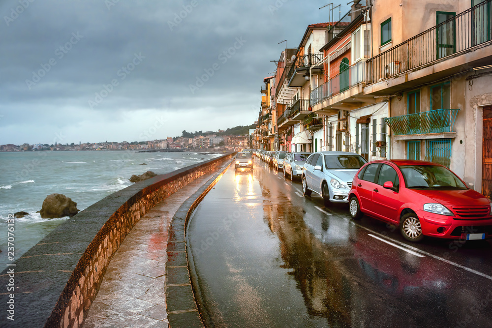 Waterfront with road in rainy weather at Giardini Naxos.  Taormina, Sicily, Italy