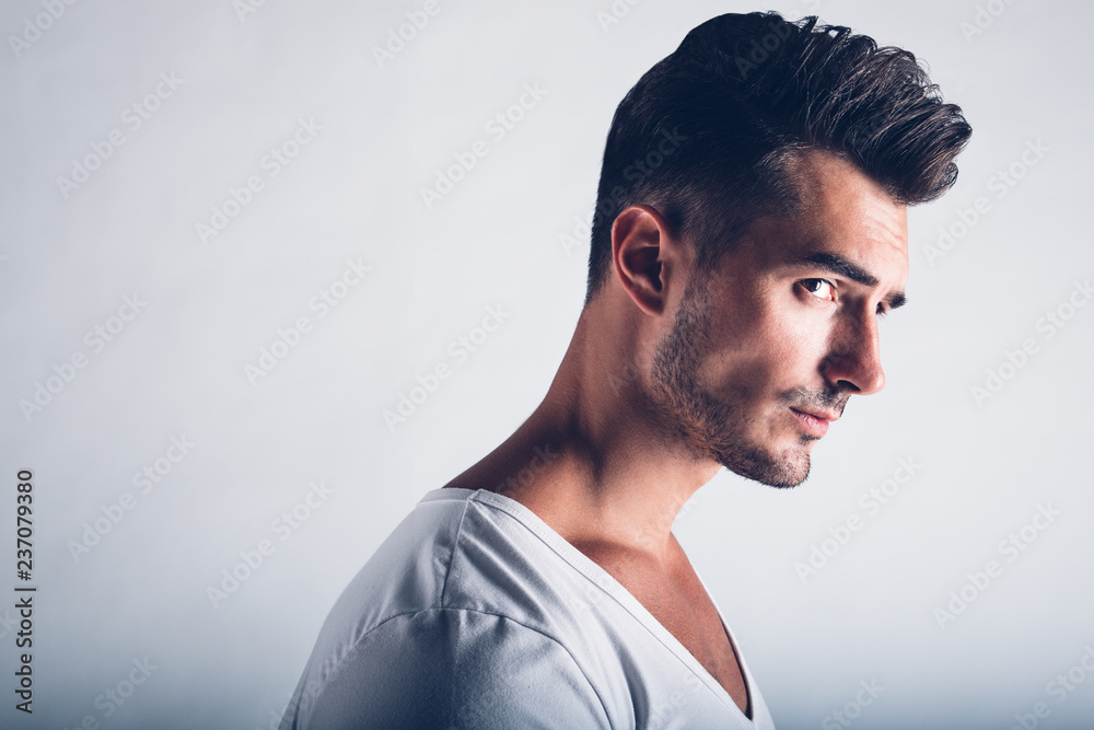 Male beauty concept. Portrait of handsome young man with stylish haircut  posing over gray background. Perfect hair & skin. Tough guy. Vogue style.  Close up. Studio shot Stock Photo | Adobe Stock
